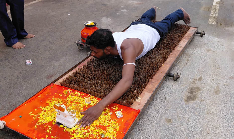 unique spectacle of faith: Undertaking 100-km journey of prostration on bed of nails out devotion to Shiva
