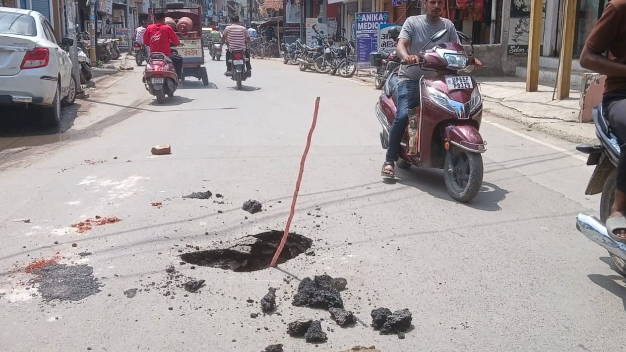 Varanasi Sigra and Chhitaipur road caved Shivpur locals placed stick pothole adding inconvenience
