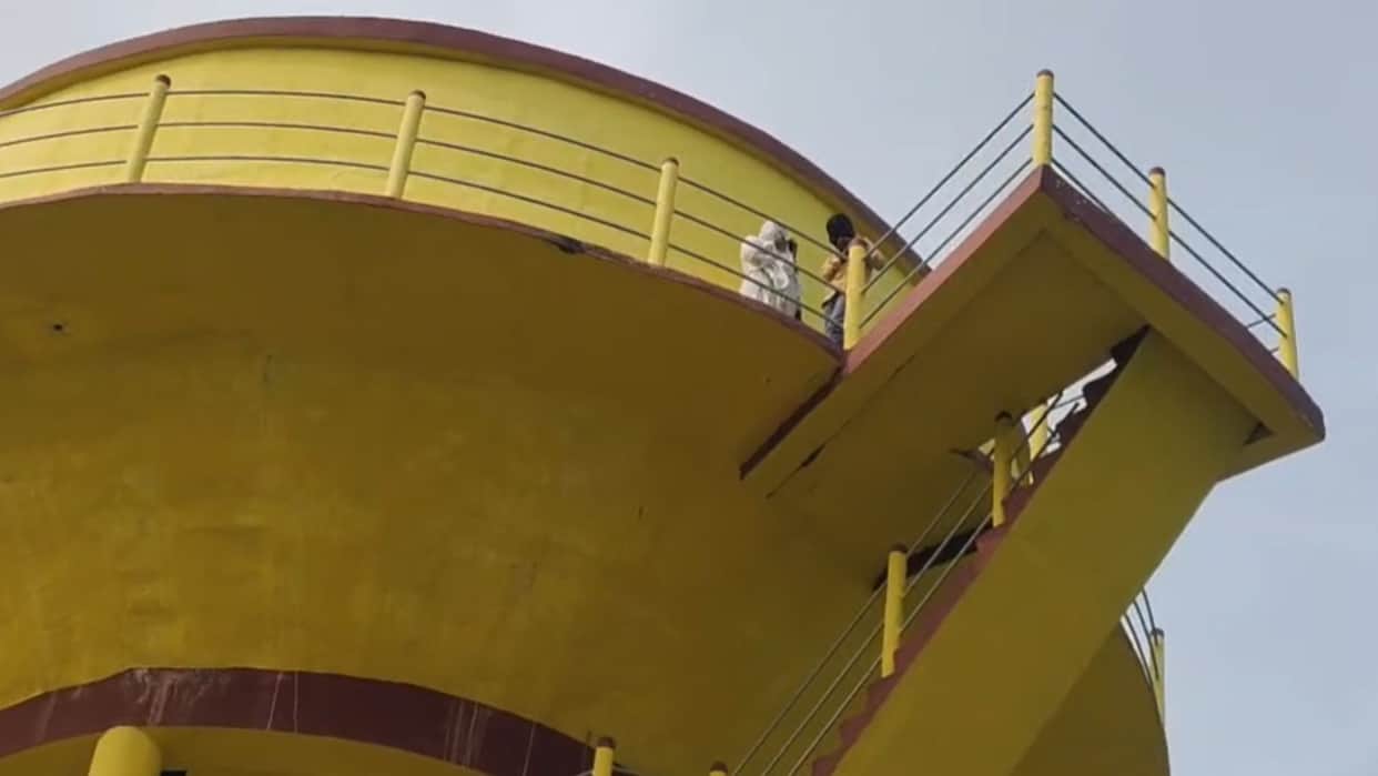 Woman climbs water tank with son alleging husband of second marriage in mau