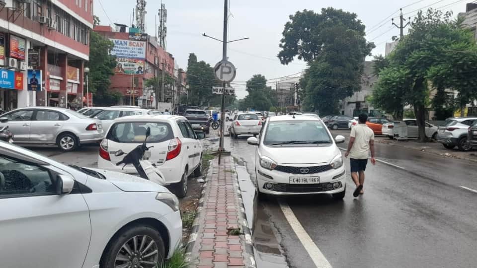 Vehicles parked on main market roads in Mohali; people facing inconvenience.