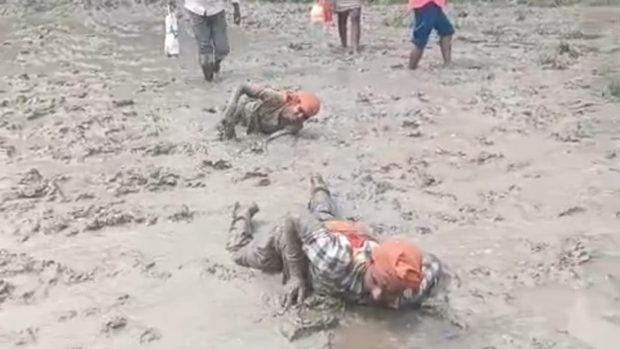 Chaos marks the path of faith Shiva devotees traverse a marshy route while performing Dandavat