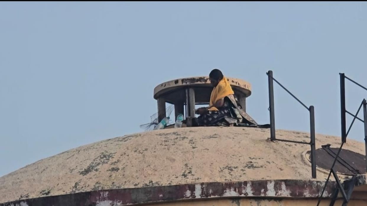 Mother of five climbs water tank; accuses Sub-Inspector of Harassment under the pretext of marriage.