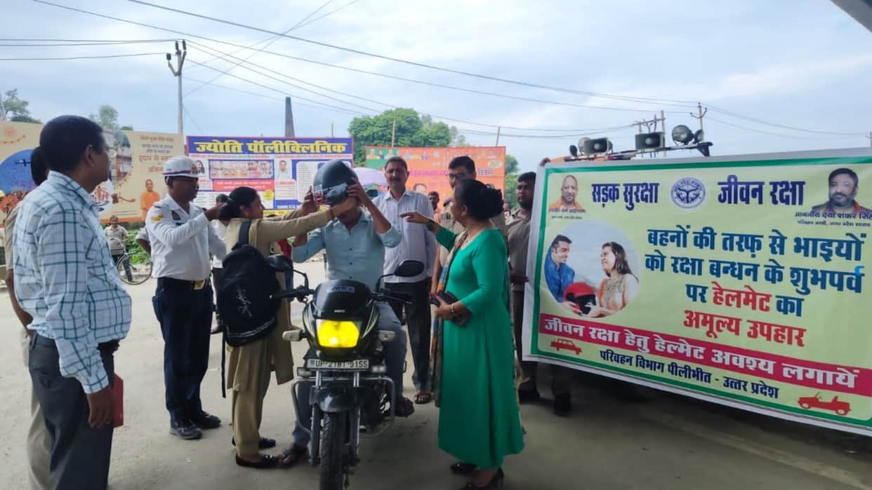 Transport Department officials distributed helmets to bike riders in Pilibhit