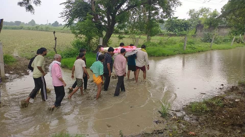 Funeral procession makes its way through waterlogged streets in mathura