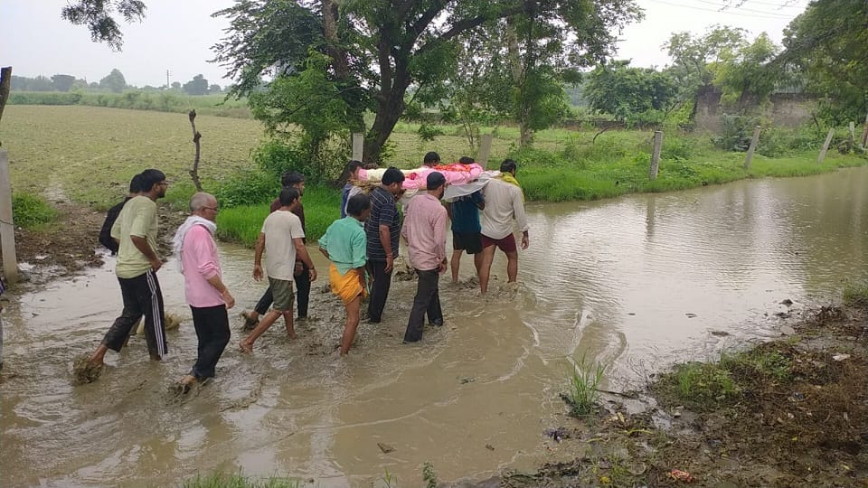 Funeral procession makes its way through waterlogged streets in mathura