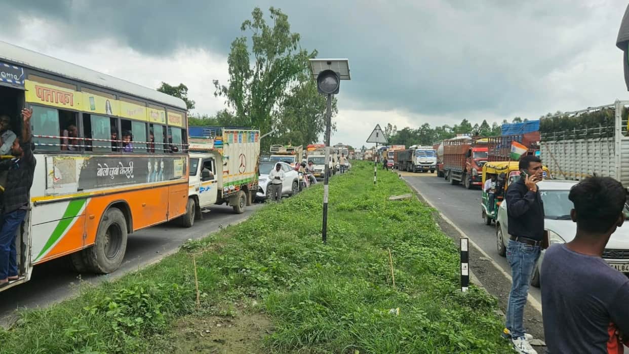 women sit on the Lucknow-Delhi Highway causing a massive traffic jam in Shahjahanpur