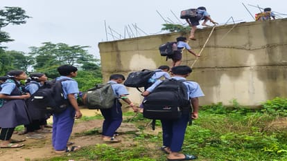 a swift river below, school bags above; children trudge to school via the stairs of an unfinished bridge