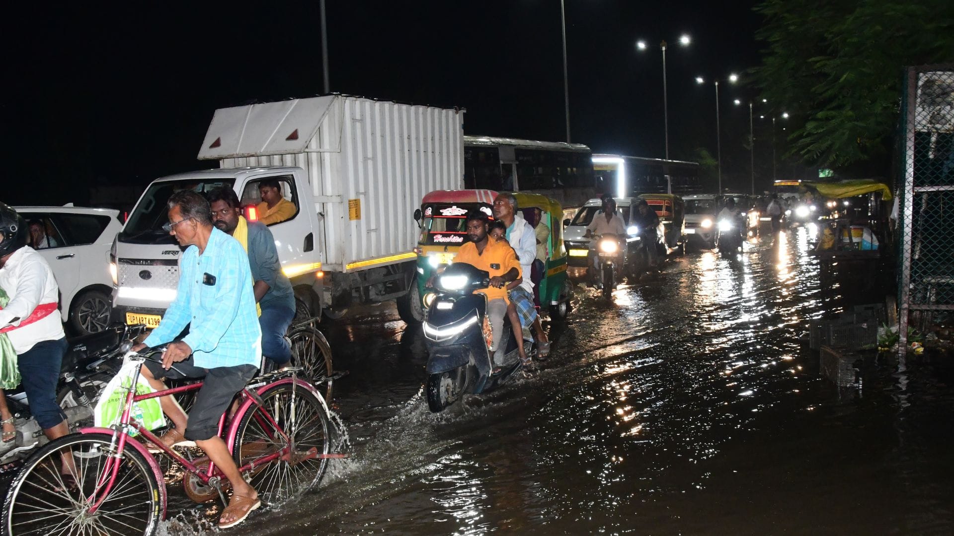 Rain from city to village in varanasi Knee-deep water people forced to drag two wheelers difficult