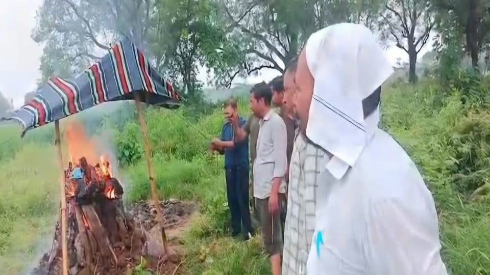 sheet stretched over a funeral pyre in the rain
