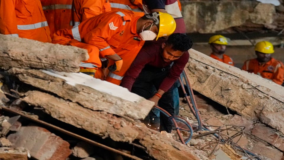 delhi building collapse Friend trapped under debris companions standing above held their breath in suspense