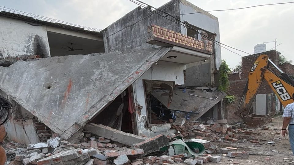 Municipal Corporation bulldozers raze drug smugglers' homes in Yamunanagar; illegal constructions demolished.
