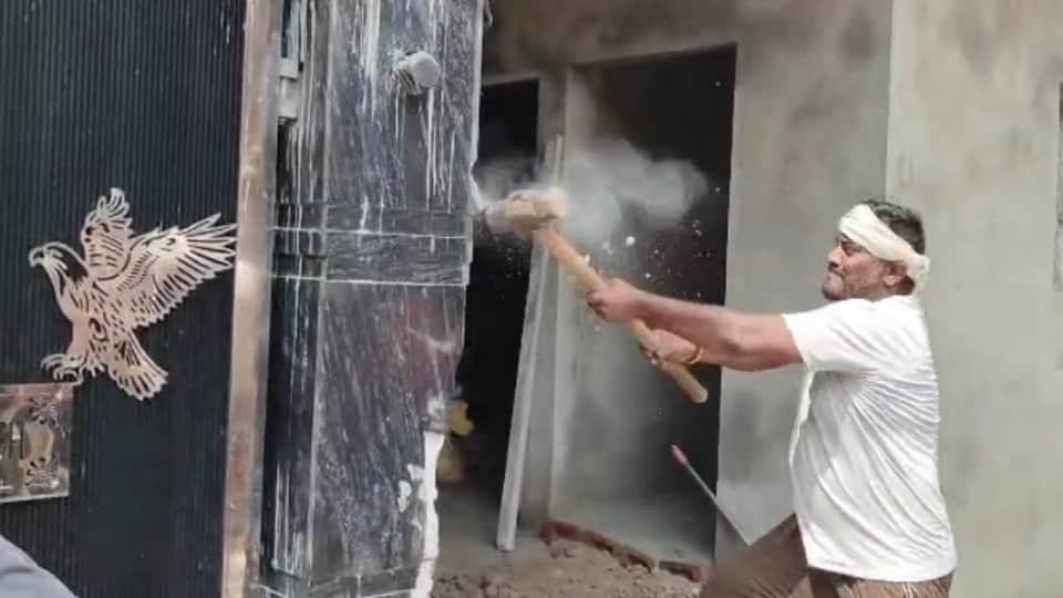 Bulldozer used on drug smuggler's house in Jalandhar.