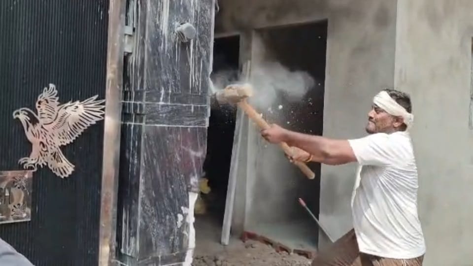 Bulldozer used on drug smuggler's house in Jalandhar.