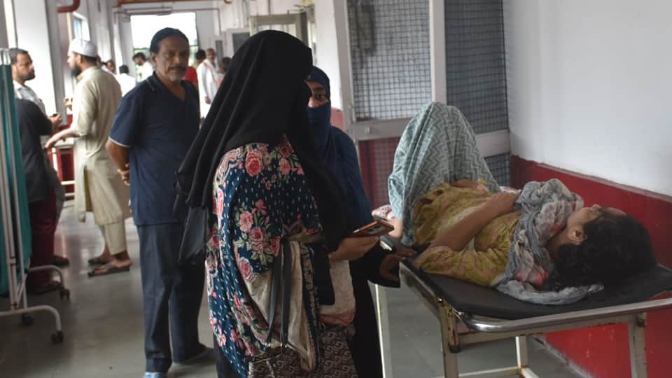 Two patients sharing a single bed at Moradabad District Hospital; this situation has persisted for five days