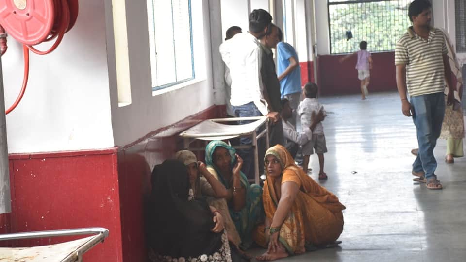 Two patients sharing a single bed at Moradabad District Hospital; this situation has persisted for five days