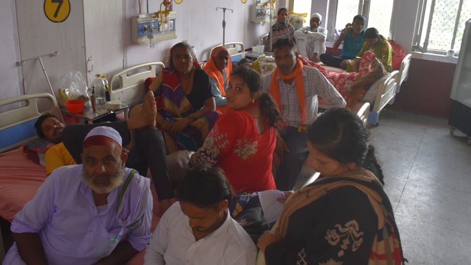 Two patients sharing a single bed at Moradabad District Hospital; this situation has persisted for five days