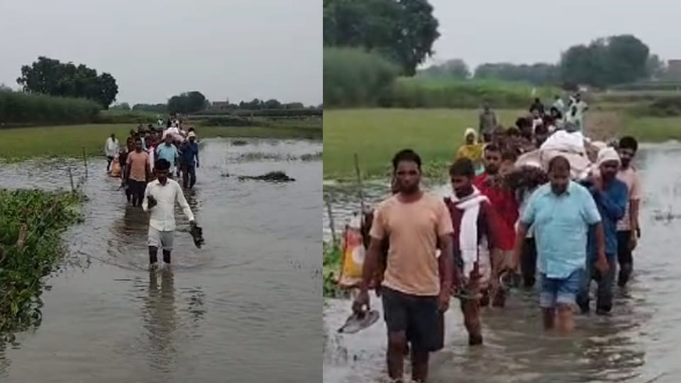 Villagers forced to wade through waterlogged public path to carry a body