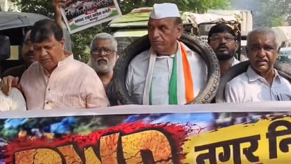 Congress's Unique Protest: 'Tyre-around-the-neck' march and offering flowers on potholes