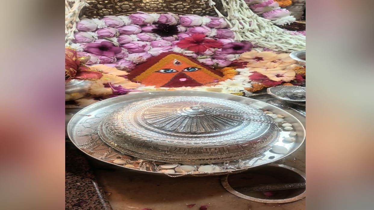 Una: Couple from Mukerian offers a 750-gram silver chhatra (ceremonial umbrella) at the shrine of Goddess Chin