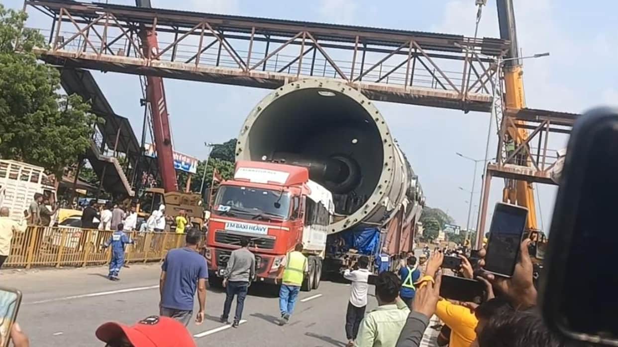 Foot overbridge lifted using two heavy-duty Hydra cranes to allow trailer loaded with boiler to pass