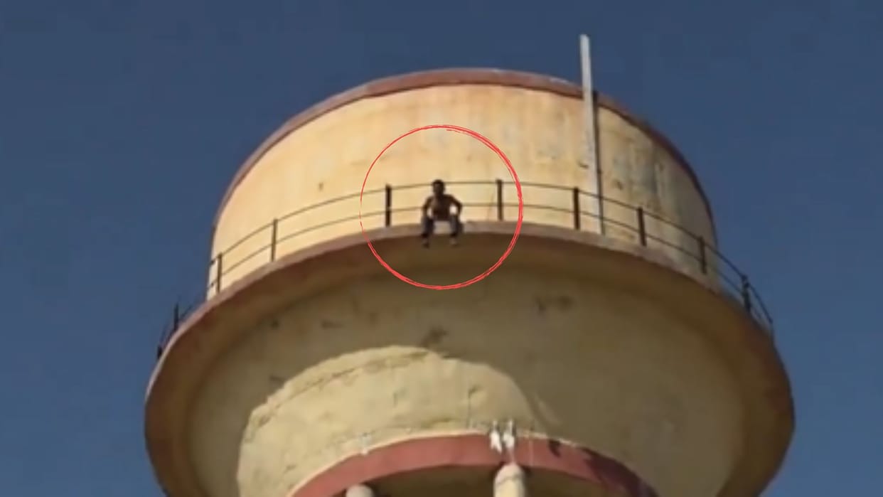 barmer youth climbs water tank blade self injury police rescue