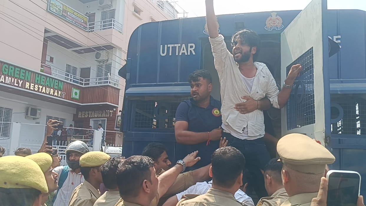 Police arrest protesting students; heated altercation ensues.