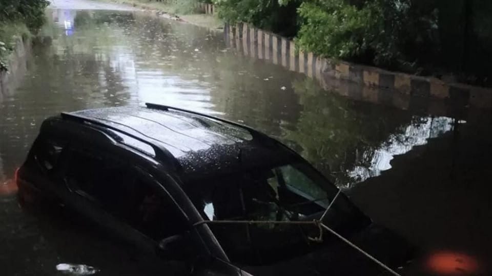 Car submerged in water-logged underpass following rain in Noida Sector 95