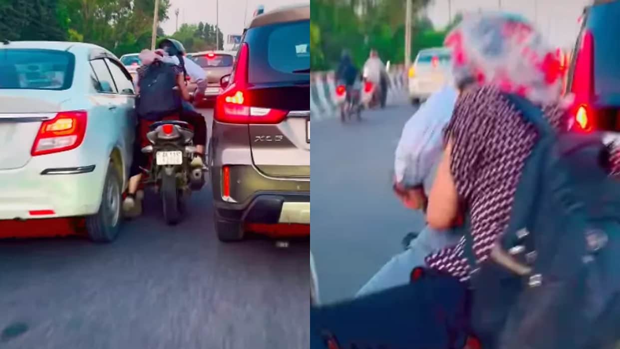 Viral Stunt Video Biker Attempts Dangerous Stunt in Heavy Traffic Falls on Road
