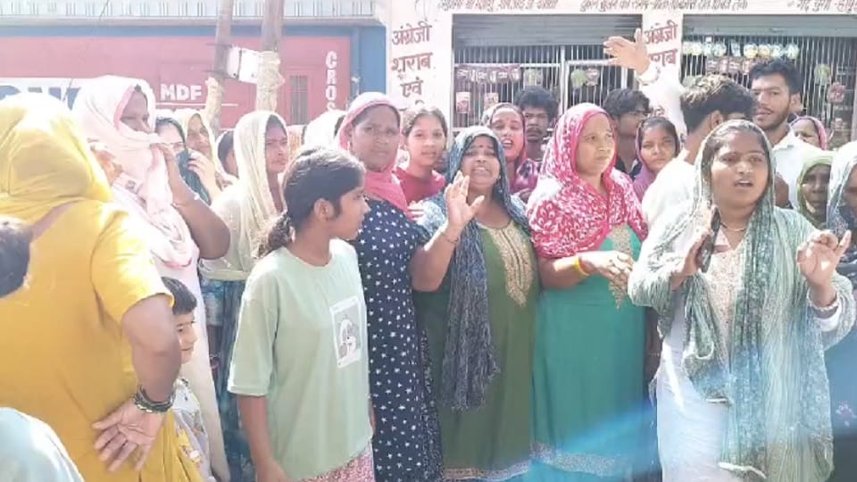 Women protest, demanding the closure of a liquor shop