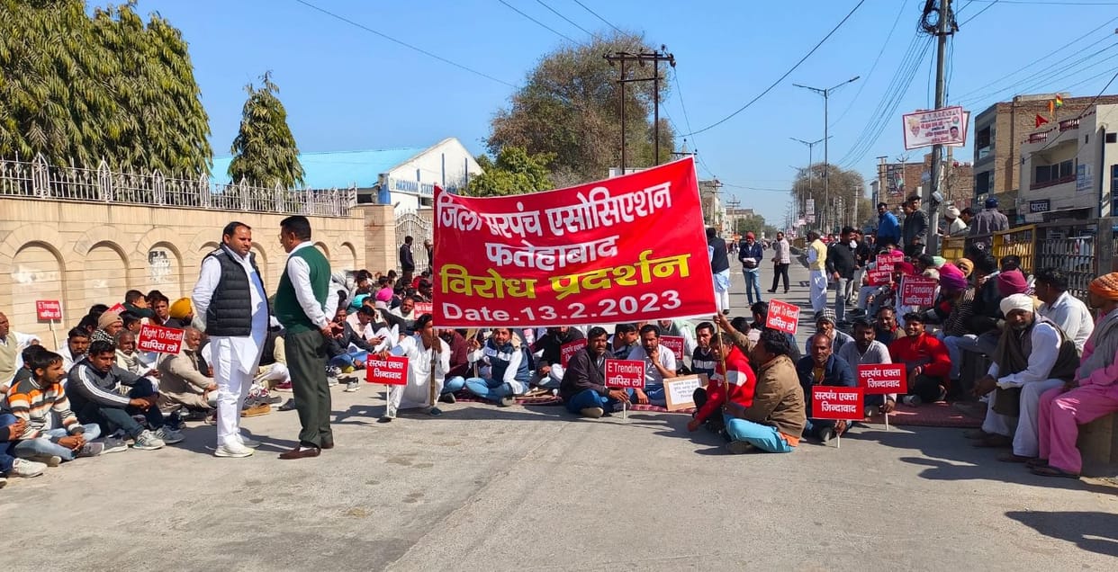 Sarpanchs block outside MLA's residence against e-tendering