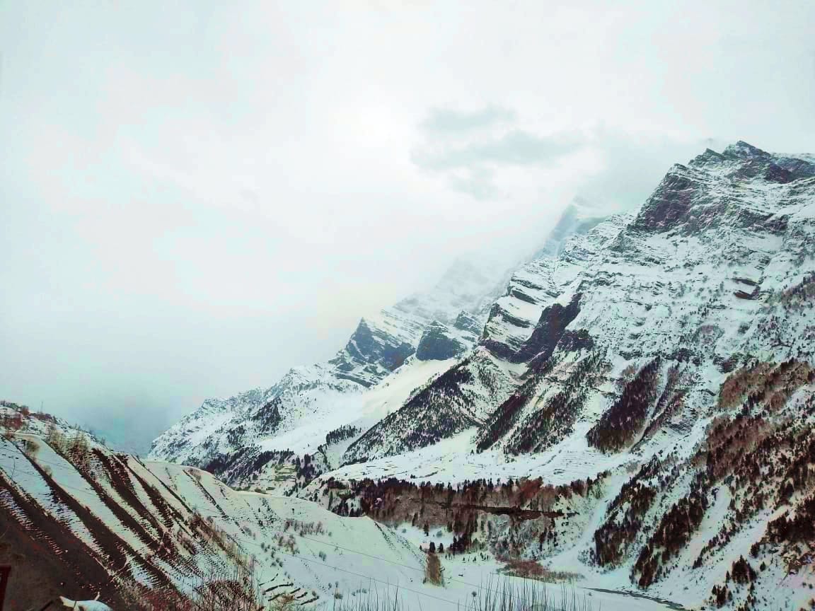 Light snowfall on high peaks including Rohtang