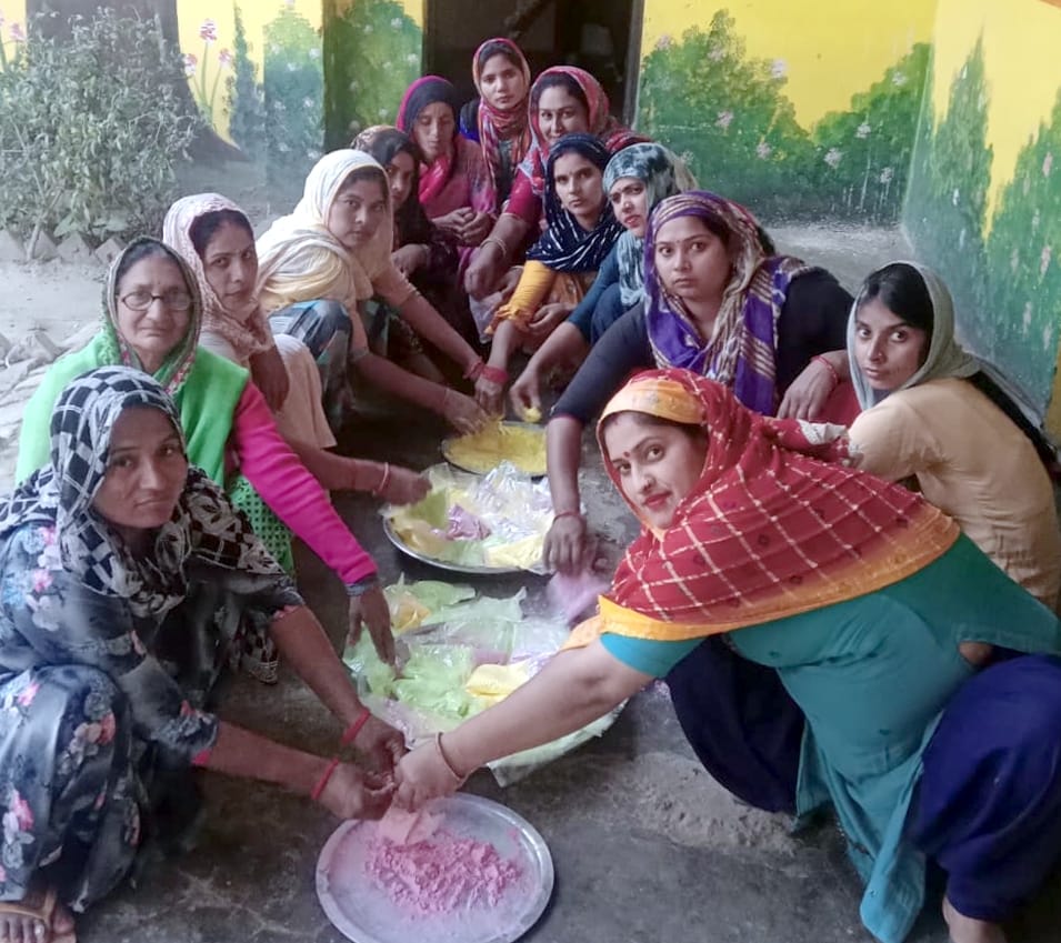 Women making Gulal to celebrate Herbal Holi