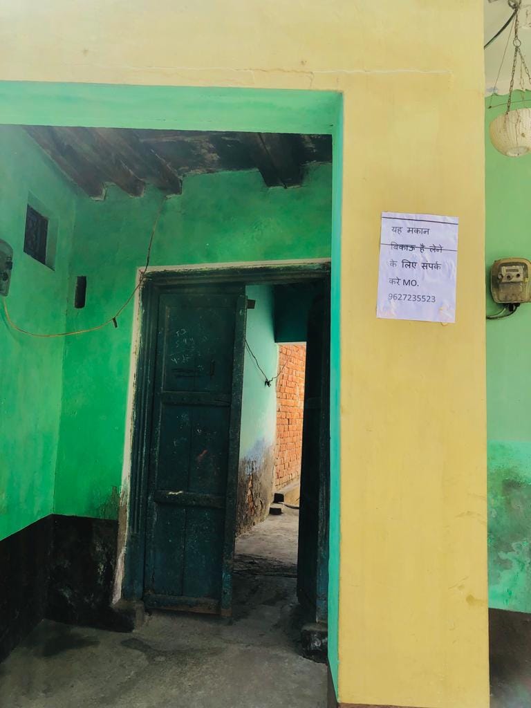 Houses are for sale pasted on houses in Mundet Kalan
