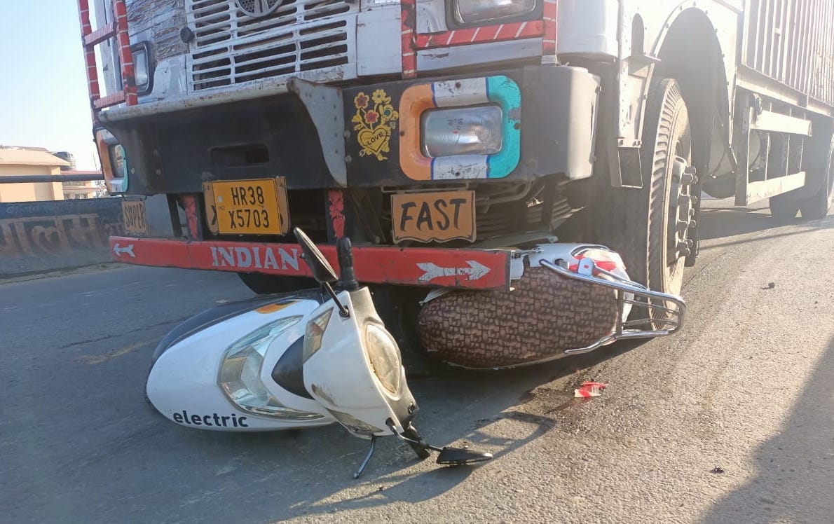 Scooty rider woman dies after being hit by a speeding container