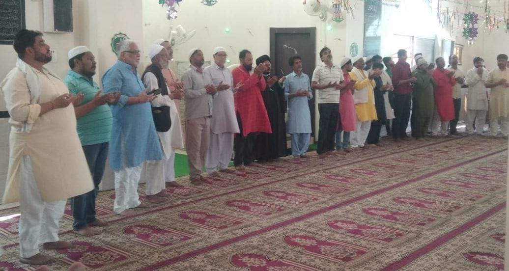 Prayers offered in mosques, raised hands for prayer