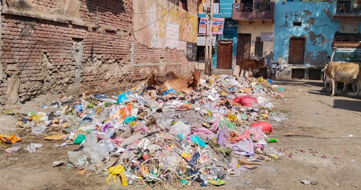 municipal council vehicles picking up garbage in papers heaps in rewari city