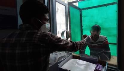 सिविल अस्पताल में कोरोना जांच के लिए सैंपल देता व्यक्ति।