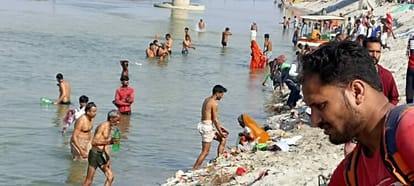 Devotees take a dip in the Ganges at Dhaighat on full moon day
