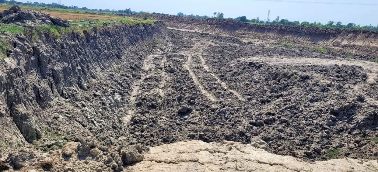 Barren land made pond for pouring soil, dam cut