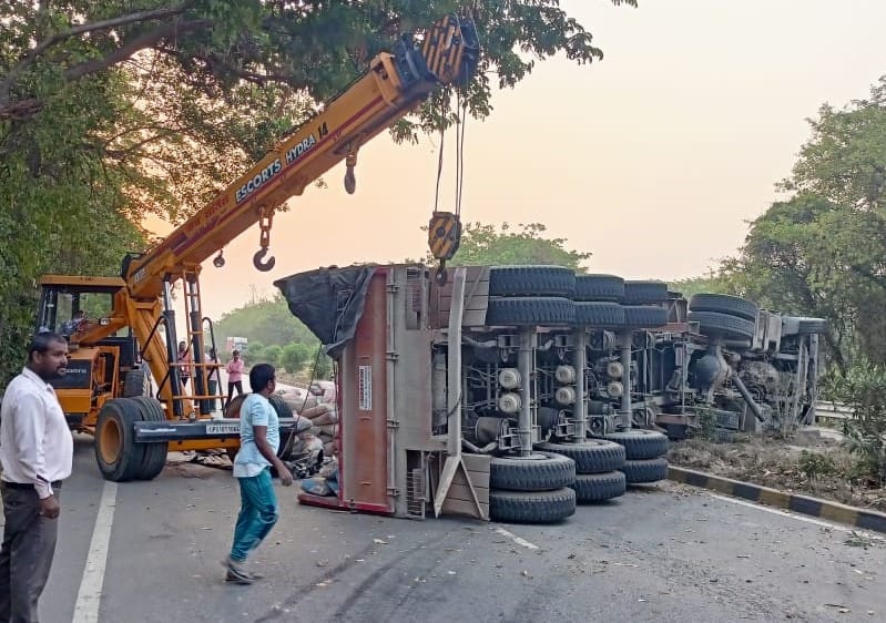 Cement laden trailer overturned after hitting the divider