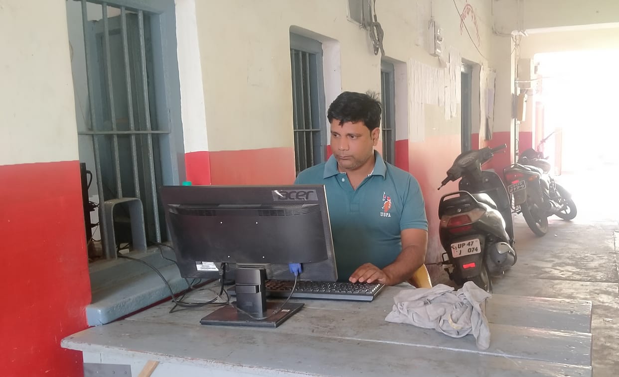 Troubled by the heat, working in the verandah