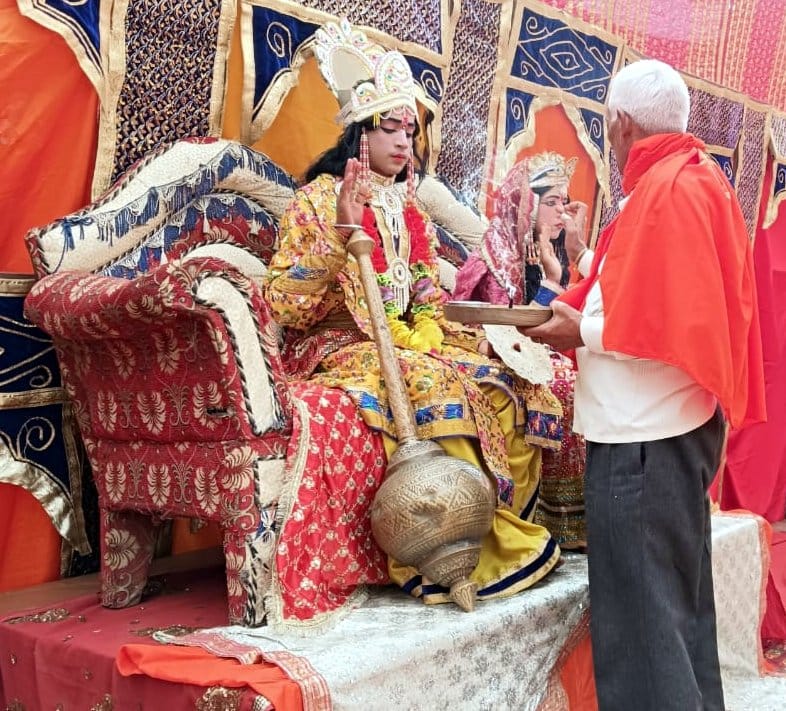 Wishing for the welfare of the world by offering oblations in Yagya