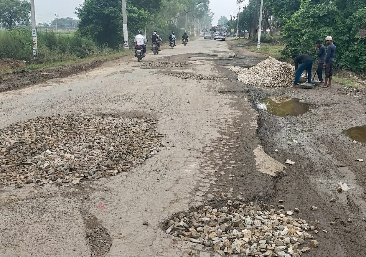 PWD filling potholes of NHAI road
