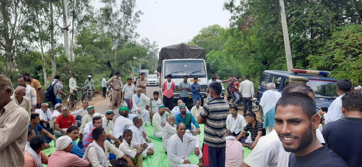 Farmers sitting on the floor on the Aligarh-Palwal road