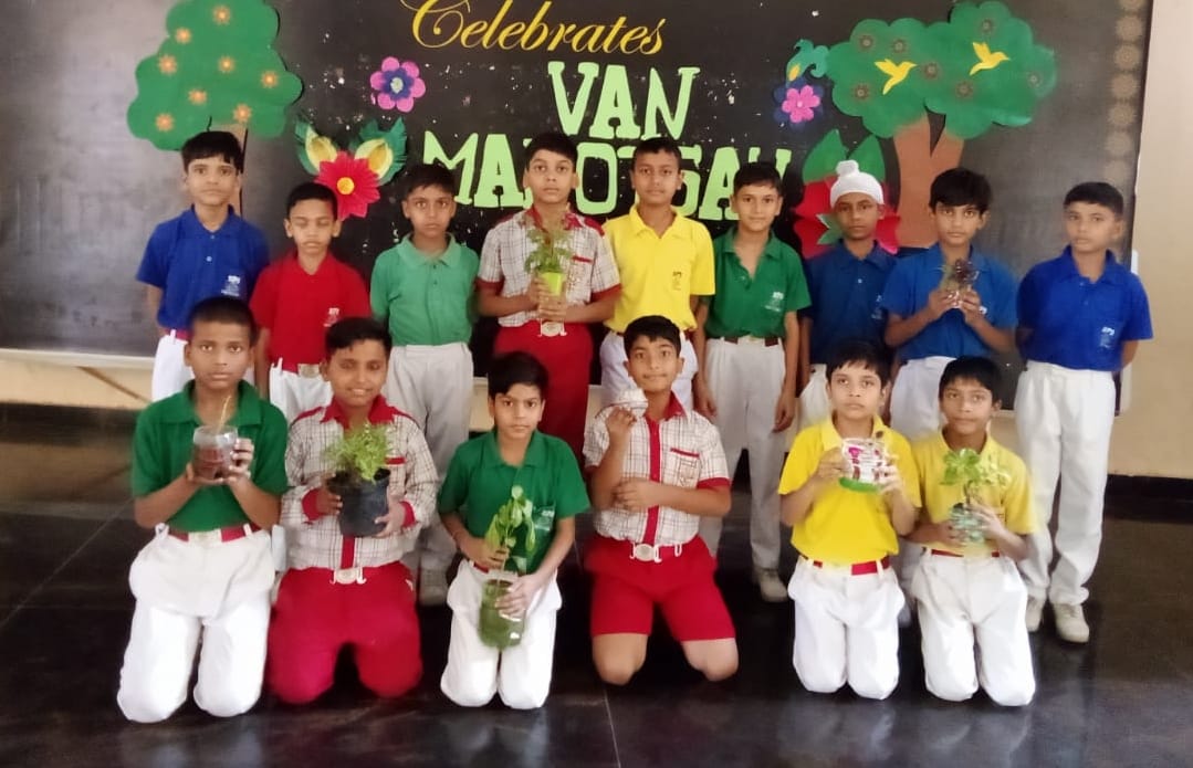 Children decorated pots, planted saplings in them
