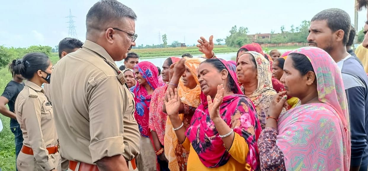 Dead body of a woman found lying on the bank of a pond, a vial of poisonous substance was kept in a bag