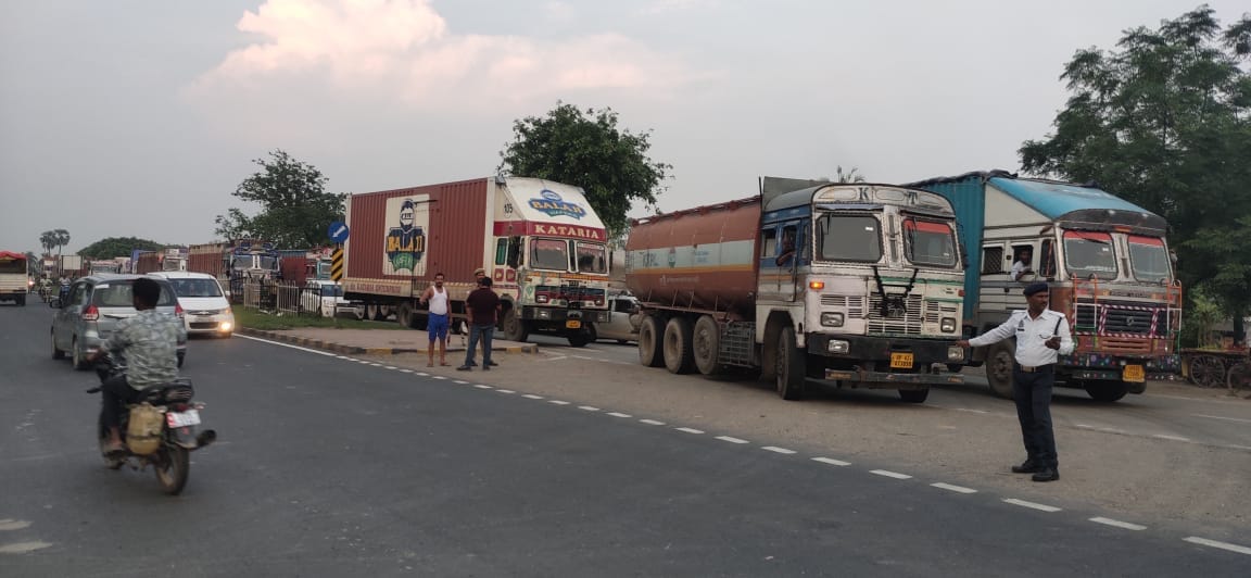 heavy vehicles are parked, small vehicles are coming out