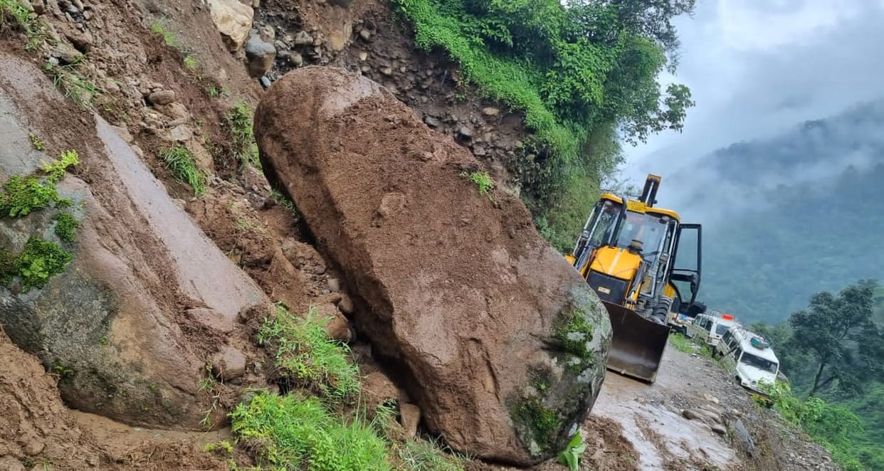Due to the closure of the roads, essential goods are being carried on the back.