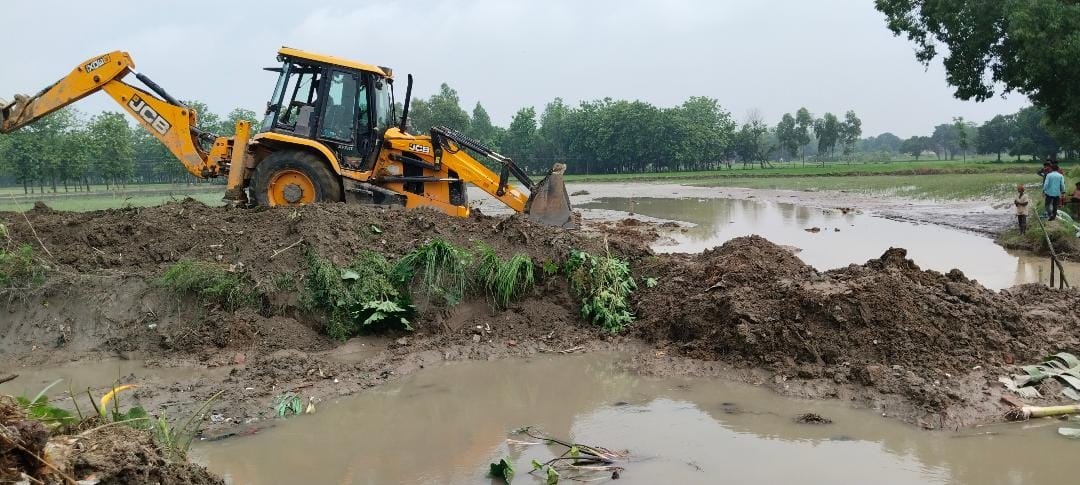 Canal track is being tied by installing JCB machine