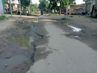Kavandia passing through the water filled on dilapidated road